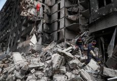 Emergency workers remove debris of a building destroyed in the course of the Ukraine-Russia conflict, in Mariupol