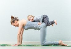 hatha yoga exercises mom with child practicing at home