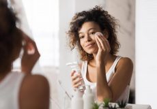 young-woman-using-face-cleanser